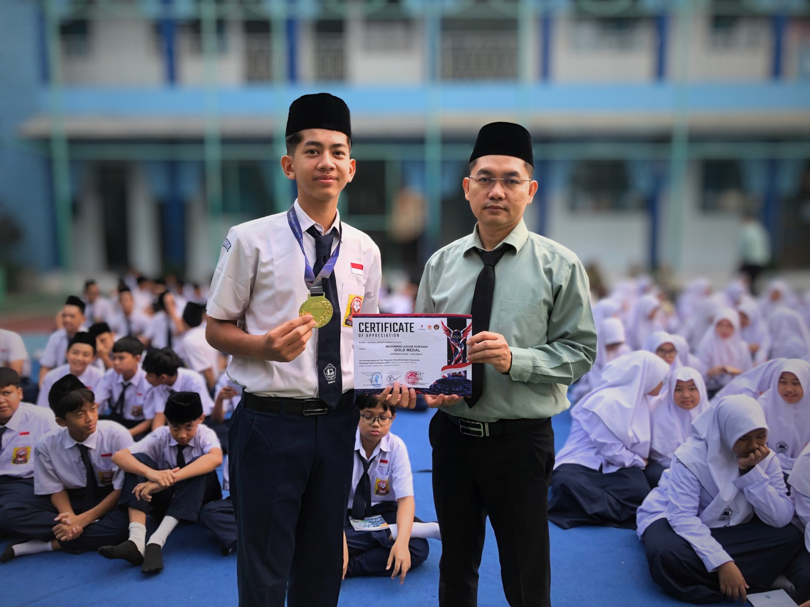 Muhammad Azzam Nurhaidi dengan bangga memegang medali dan piagam penghargaan